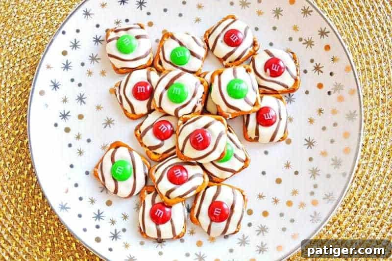 Effortless 3-Ingredient Holiday Pretzel Kisses 8 A stack of beautifully finished Christmas Pretzel Hugs, showcasing their appealing colors and textures, ready for a holiday gathering.