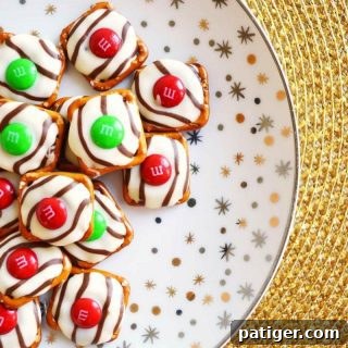 Salty-sweet Christmas pretzel hugs treats are quick and easy to make with just 3 ingredients: square pretzels, M&Ms, and Hershey's Hugs.