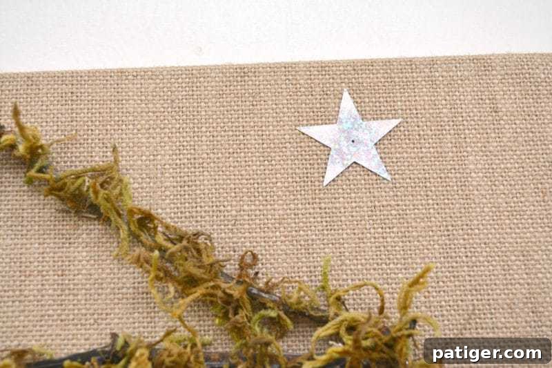 Pebble Art Nativity Canvas 8 Securely hot glue all your rock nativity characters, including Mary, Joseph, and other figures, into their final positions within the stable on the burlap canvas, bringing the scene to life.