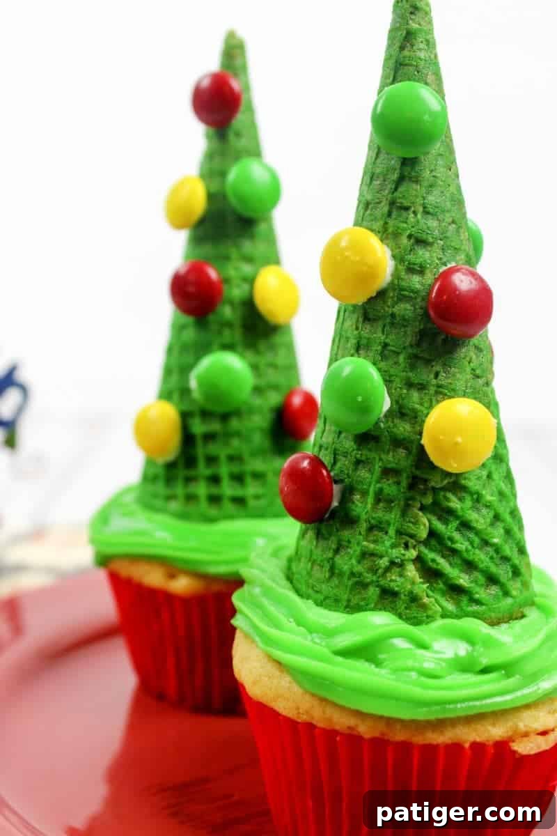 Delicious and fun Christmas tree cone cupcakes made with sugar cones and M&M's for ornaments. Easy to decorate and perfect for holiday parties.