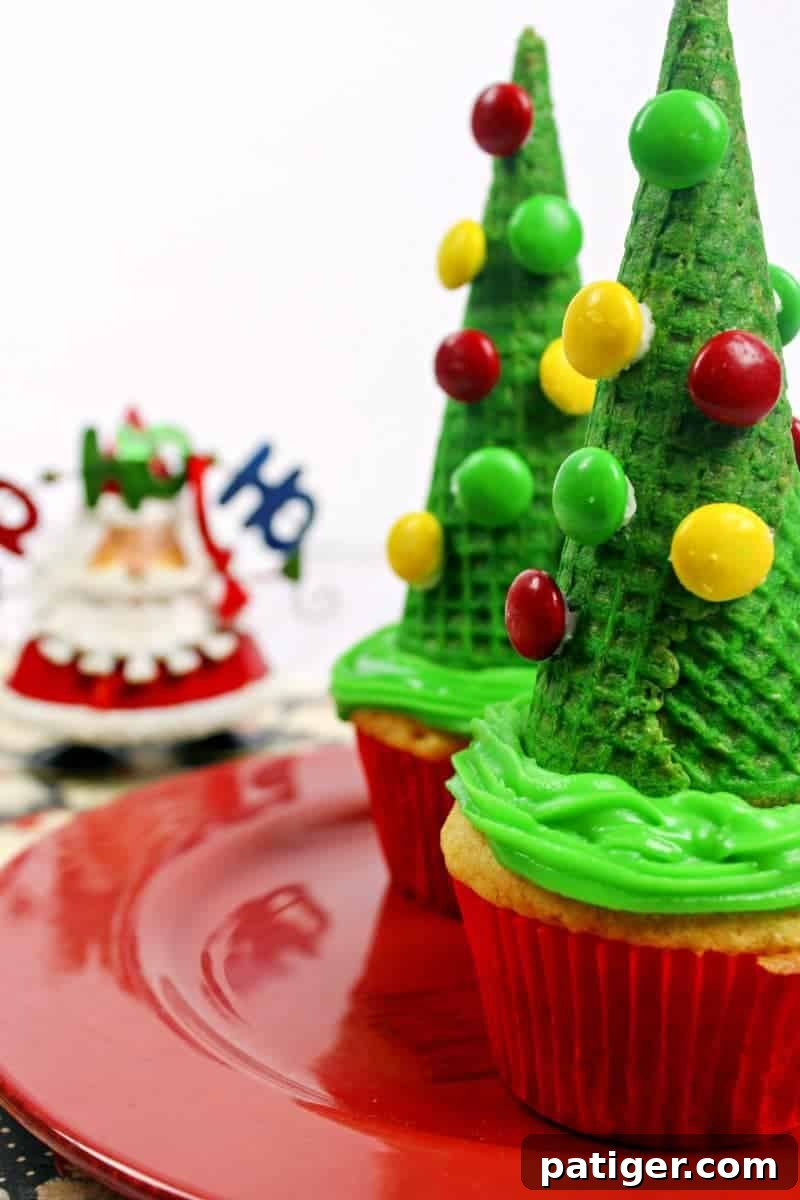 Adorable and easy-to-make Christmas tree ice cream cone cupcakes decorated with colorful M&M's.