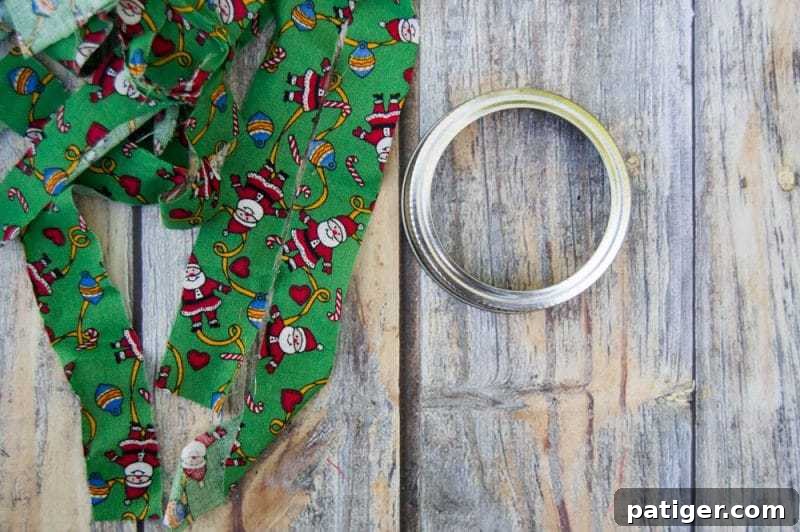 Mason canning jar lid Christmas wreath ornaments are great for giving your tree that homemade rustic feel, and can be customized with any color fabric.