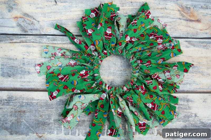 Mason canning jar lid Christmas wreath ornaments are great for giving your tree that homemade rustic feel, and can be customized with any color fabric.
