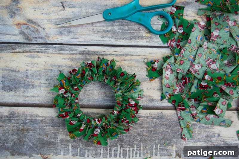 Mason canning jar lid Christmas wreath ornaments are great for giving your tree that homemade rustic feel, and can be customized with any color fabric.