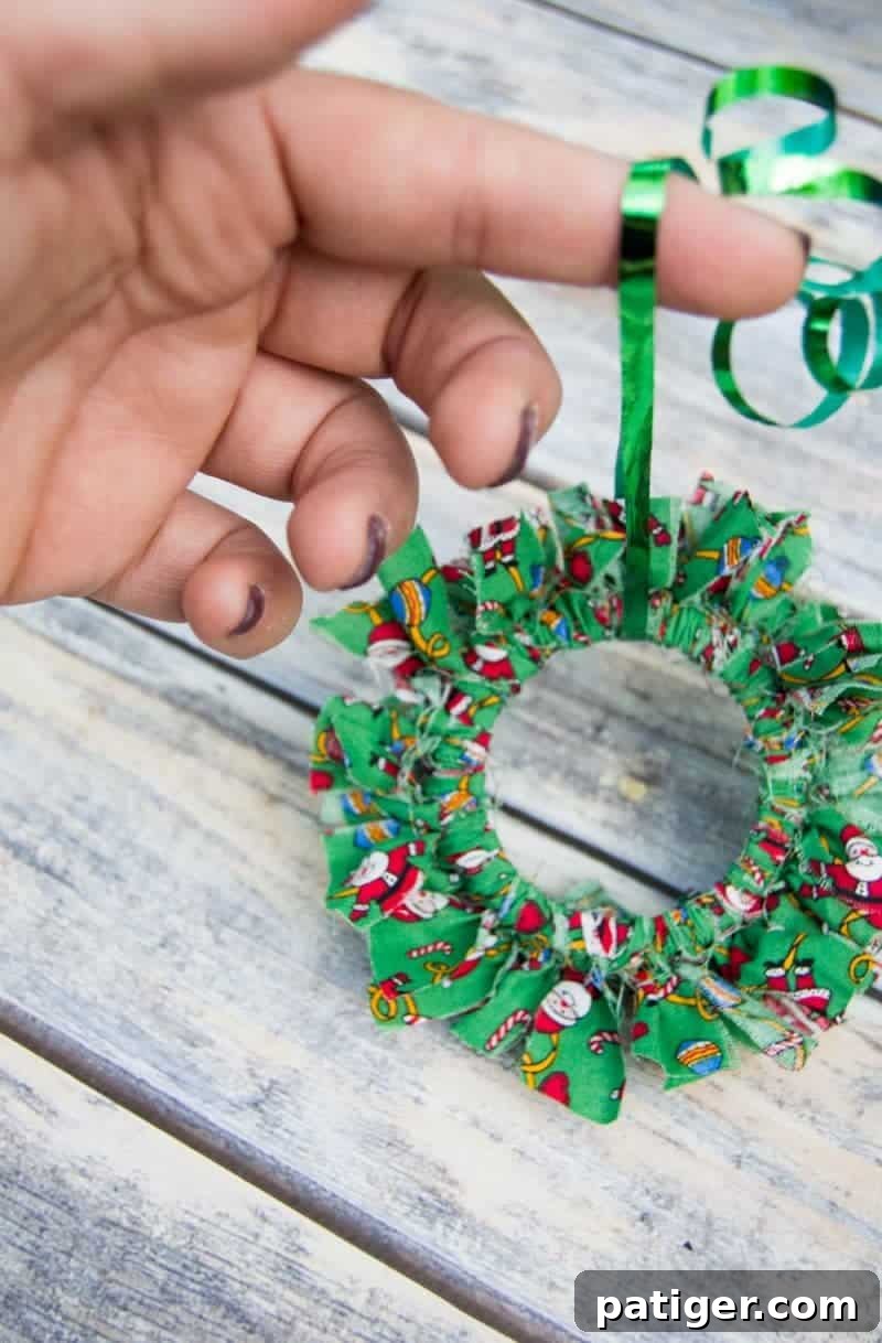 Mason canning jar lid Christmas wreath ornaments are great for giving your tree that homemade rustic feel, and can be customized with any color fabric.