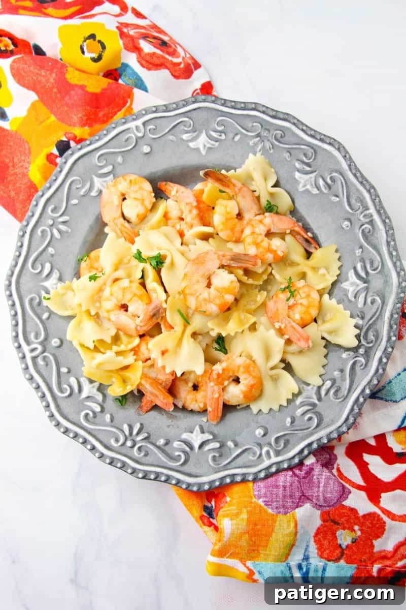 Garlic Butter Instant Pot Shrimp Scampi 2 Plump shrimp swimming in a vibrant garlic butter sauce with fresh parsley, served over perfectly cooked pasta in an Instant Pot.