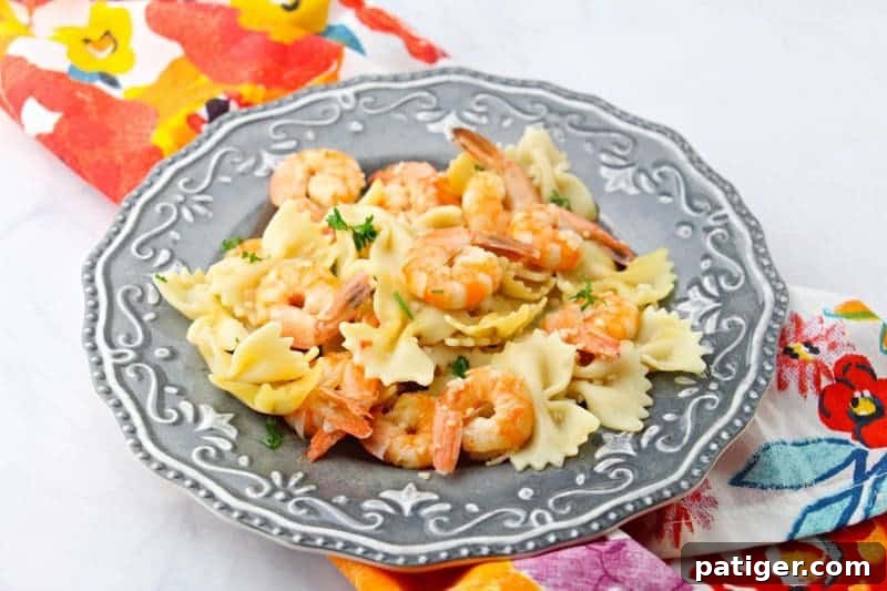 Garlic Butter Instant Pot Shrimp Scampi 4 A serving of flavorful Instant Pot shrimp scampi presented with fresh parsley garnish, ideal for pairing with crusty bread.