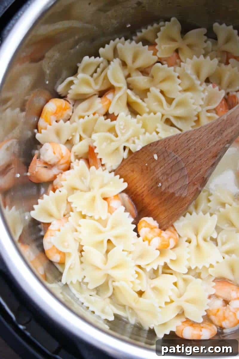 Garlic Butter Instant Pot Shrimp Scampi 8 Perfectly cooked Instant Pot shrimp scampi, ready to be tossed with pasta or rice and seasoned to taste.