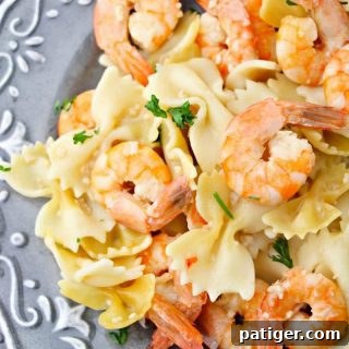Delicious Instant Pot Shrimp Scampi served over pasta, garnished with fresh parsley.