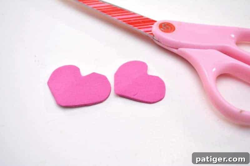Fruity Love Bug Valentine Treats 5 Step 1: Cutting heart shapes from pink craft foam for love bug feet.