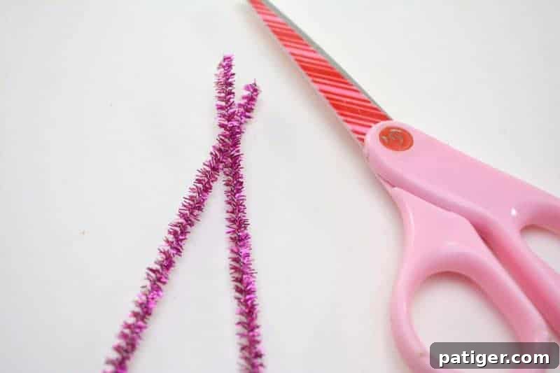 Fruity Love Bug Valentine Treats 8 Step 4: Cutting a sparkly pipe cleaner in half to prepare for antennae.