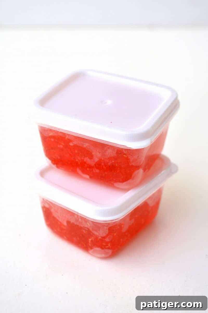 Sweetheart Slime Creation and Complimentary Gift Tags 9 Placing homemade red glitter slime into small plastic containers