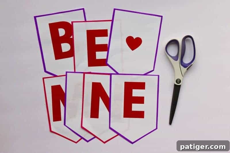 Begin your easy DIY Valentine decor project by cutting out each flag of the "Be Mine" Valentine banner free printable for a festive touch.