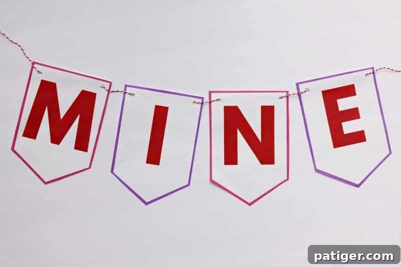 Complete your easy DIY Valentine decor: string each flag onto twine to create your beautiful "Be Mine" Valentine banner, ready to display!