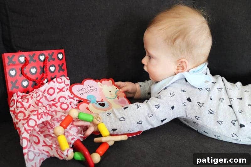 Capturing the joy of a baby's first Valentine's Day, as they eagerly explore their gifts and cards – a truly heartwarming family moment.