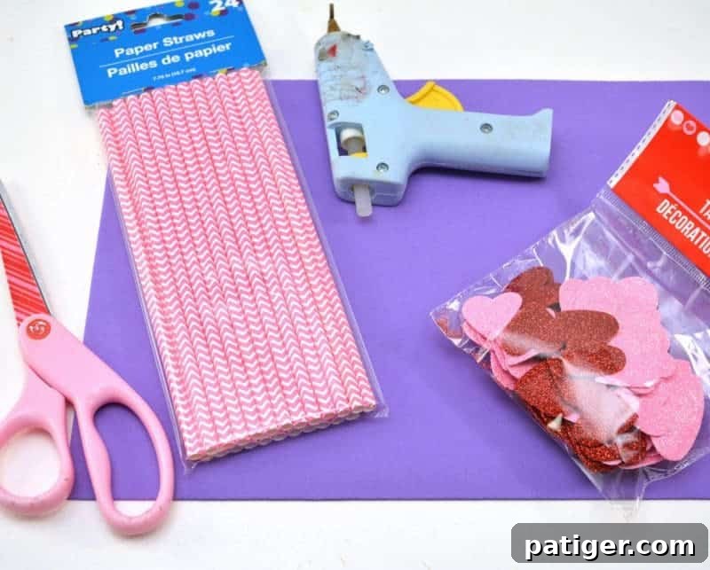 XOXO Tic Tac Toe 4 Craft materials laid out for a DIY Valentine's Day Tic Tac Toe game: foam sheet, heart scatter, straws, glue, scissors