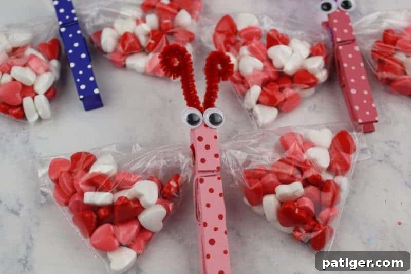 Trimming and curling pipe cleaners to form a butterfly's antennae, completing the snack bag craft