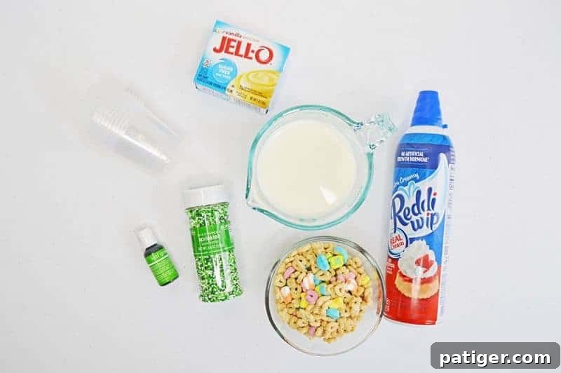 Magically Delicious St Patricks Day Pudding Parfaits 4 Ingredients laid out for St. Patrick's Day Pudding Parfaits, including Lucky Charms and pudding mix