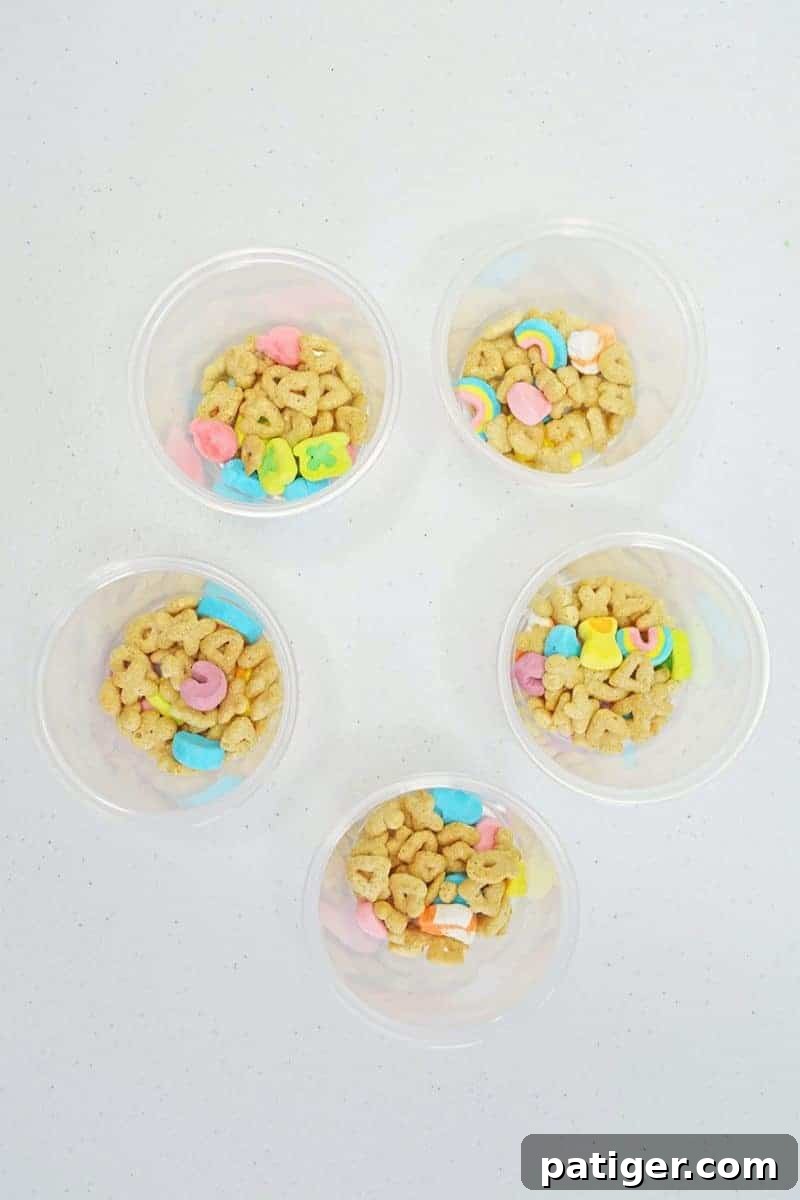Magically Delicious St Patricks Day Pudding Parfaits 7 A layer of Lucky Charms cereal at the bottom of a clear cup