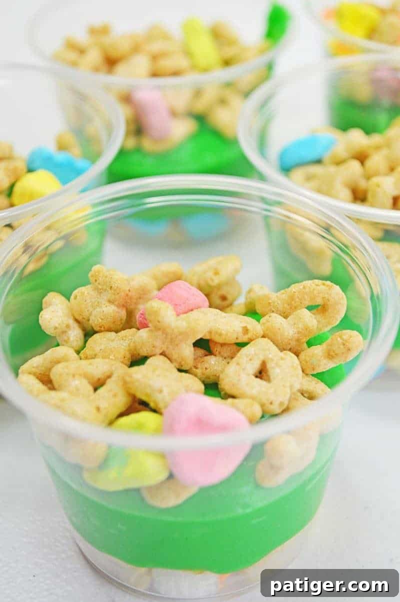 Magically Delicious St Patricks Day Pudding Parfaits 9 Adding a second layer of Lucky Charms cereal on top of the green pudding