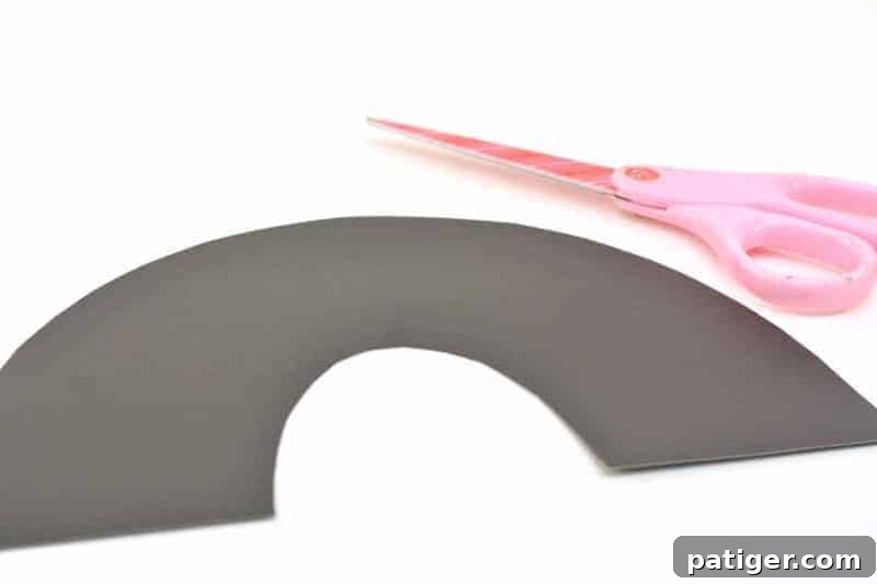 Scissors cutting out cardstock rainbow shape
