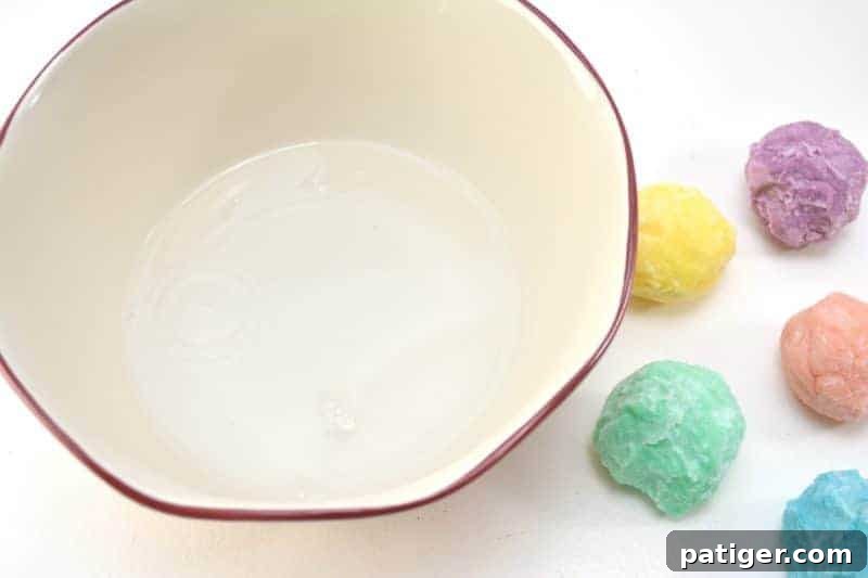 Enchanted Rainbow Stones: A Hidden Fortune 12 A child enthusiastically dropping a frozen magic rainbow rock into a bowl of vinegar, anticipating the fizz and treasure.