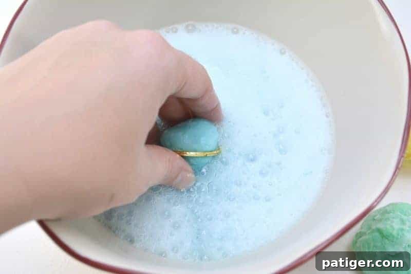Enchanted Rainbow Stones: A Hidden Fortune 4 Close-up of a child's hands carefully revealing a hidden treasure from a dissolved magic rock, amidst colorful fizz.