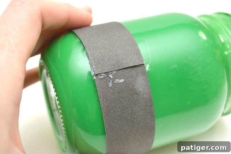 Gluing the black glitter cardstock strip to the bottom of the painted mason jar