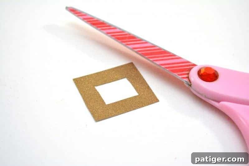 Cutting a small square and inner square from gold glitter cardstock for the buckle