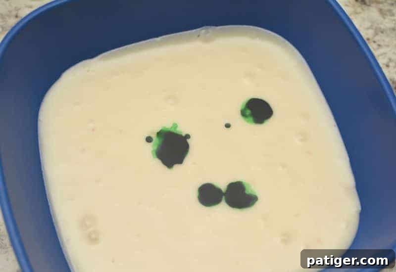 Pouring small batches of warm fudge mixture into individual bowls to add different shades of green food coloring for St. Patrick's Day fudge.