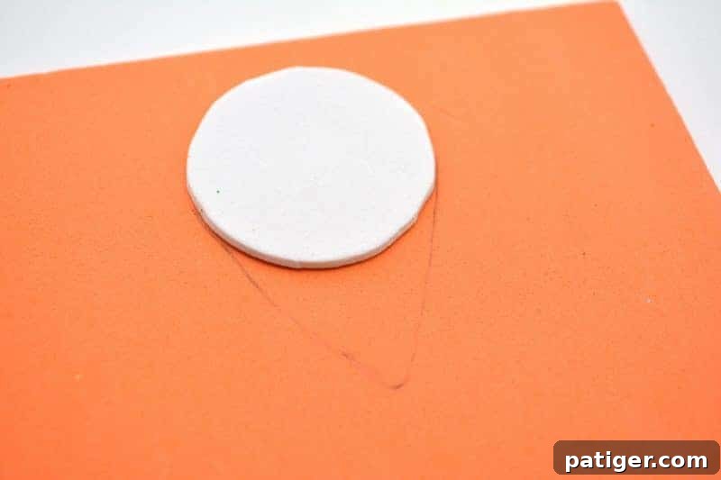 Craft a Lucky Leprechaun from Popsicle Sticks for St Patricks Day 6 Step 2: Carefully cutting an orange craft foam beard shape, designed to fit snugly around the previously cut white head circle.