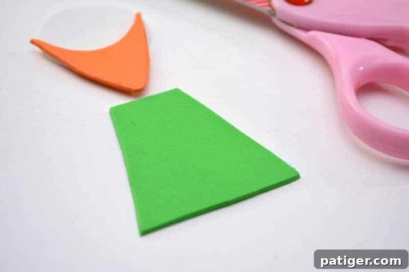 Craft a Lucky Leprechaun from Popsicle Sticks for St Patricks Day 7 Step 3: Shaping a green trapezoid from craft foam, which will become the body or shirt of the charming leprechaun.