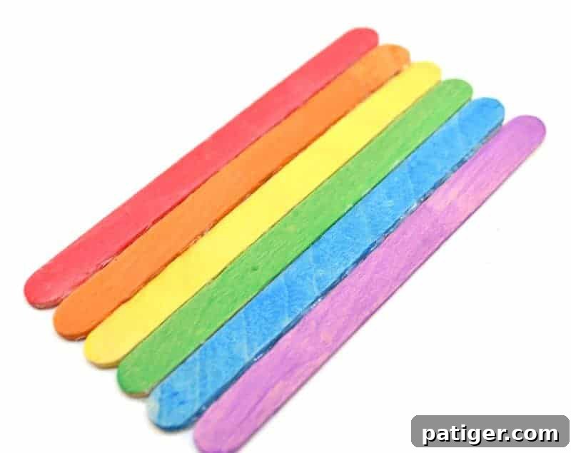 St Patricks Day Lucky Rainbow Gold Planter 6 Hot gluing rainbow-colored popsicle sticks side by side to form a solid rainbow arch.