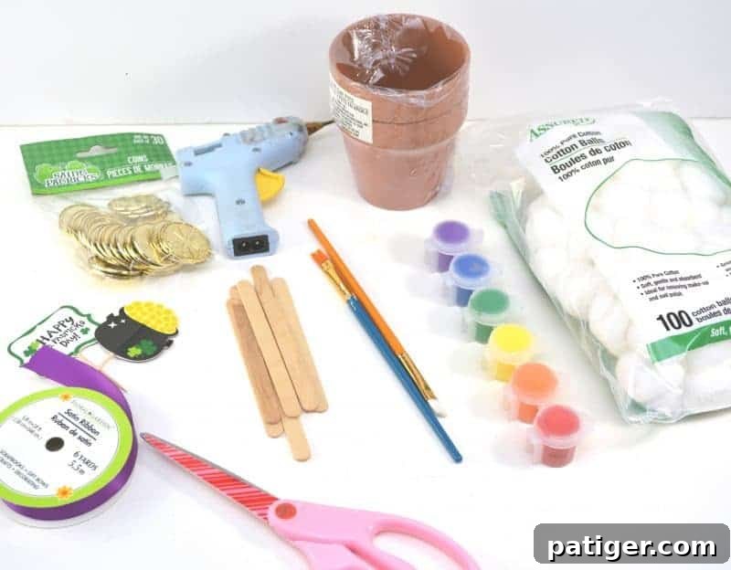 St Patricks Day Lucky Rainbow Gold Planter 3 Essential materials laid out for the DIY Rainbow Pot of Gold Planter craft, including paint, brushes, popsicle sticks, cotton balls, and a terra cotta pot.