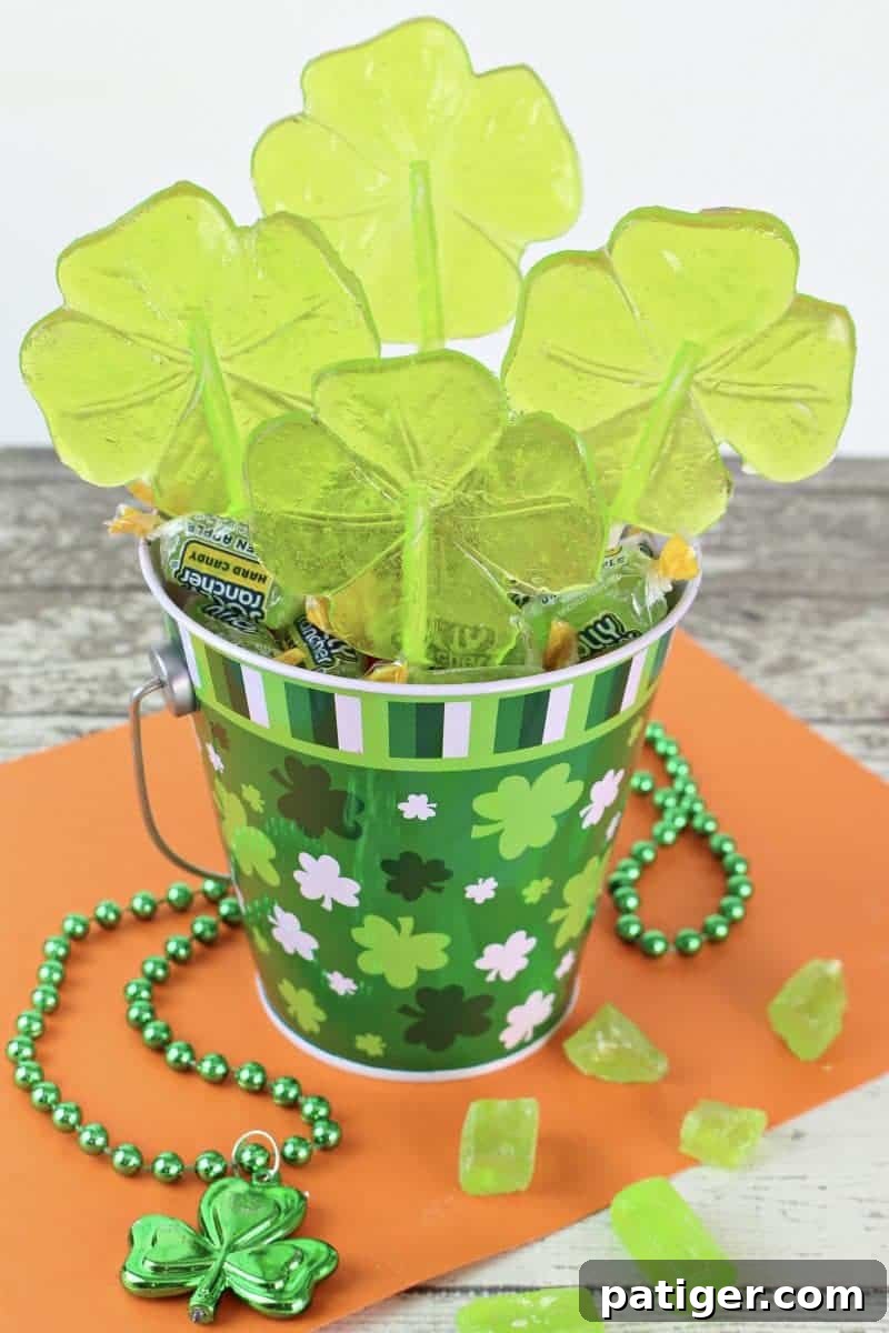 Lucky Shamrock Pops for St Patricks Day 2 Vibrant Green Shamrock Lollipops: The perfect easy St. Patrick's Day party treat made with Jolly Rancher candies.