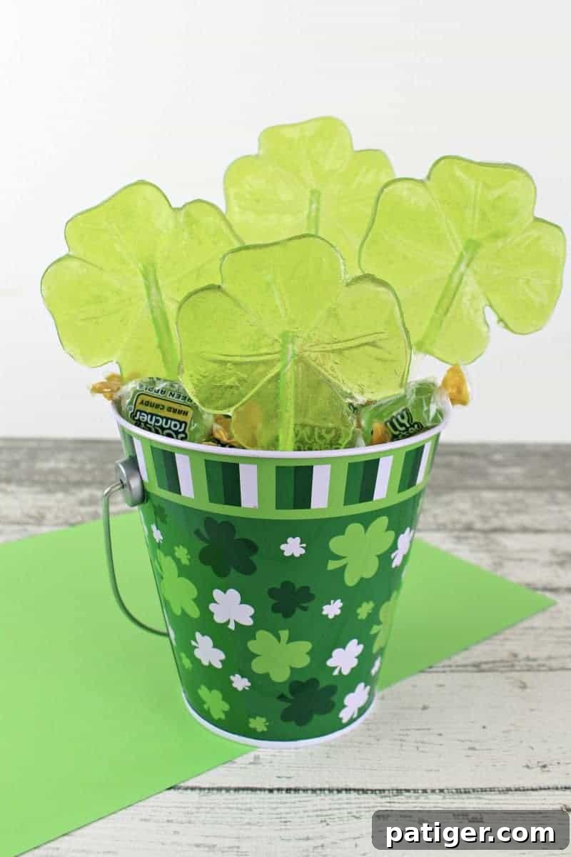 Lucky Shamrock Pops for St Patricks Day 3 Delightful green shamrock lollipops crafted from Jolly Ranchers, perfect for a quick and easy St. Patrick's Day dessert.
