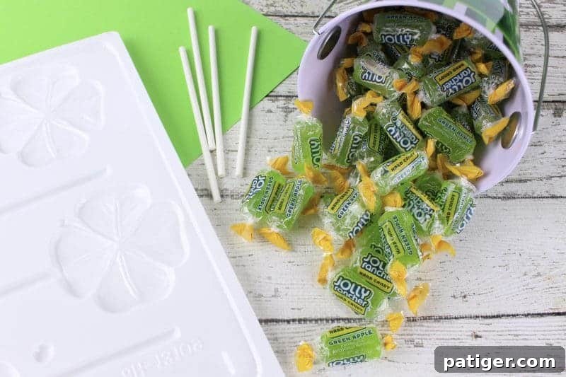 Lucky Shamrock Pops for St Patricks Day 4 All the necessary supplies to make green shamrock Jolly Rancher lollipops: candies, molds, sticks, and tools.