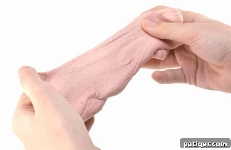 Homemade edible silly putty stretched and molded, perfect for sensory play and taste-safe exploration.