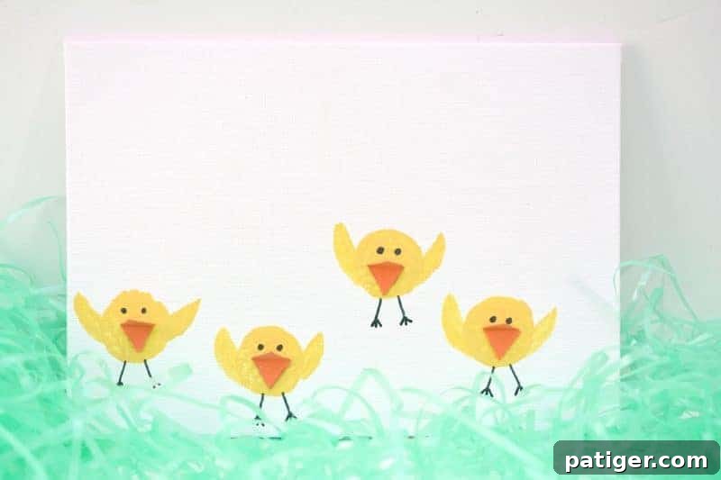 A completed Easter chicks wine cork stamping craft, featuring multiple yellow chicks with orange beaks, black eyes, and painted wings on a white background.