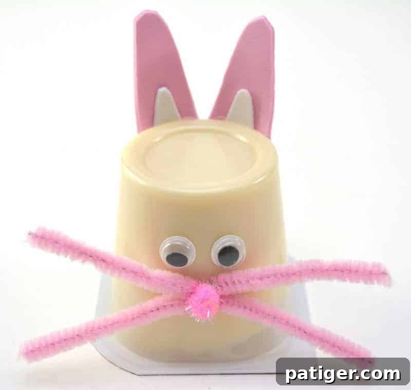 The final, complete Easter Bunny Pudding Cup, now adorned with its whimsical whiskers, showcasing an utterly adorable and finished Easter craft for kids.