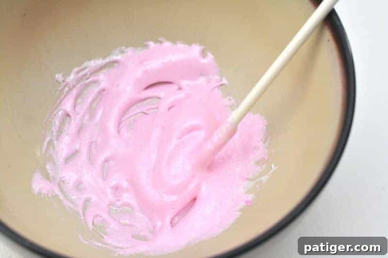 Stirring melted marshmallow Peep to create a smooth, thick puffy paint consistency for kids' crafts.