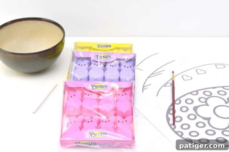 Arrangement of supplies needed for DIY Peeps puffy paint: marshmallow Peeps, microwave-safe bowl, and paintbrush.