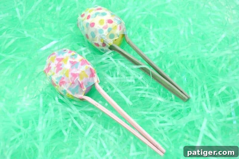 Colorful Easter egg maracas made from plastic eggs and spoons, decorated with washi tape.