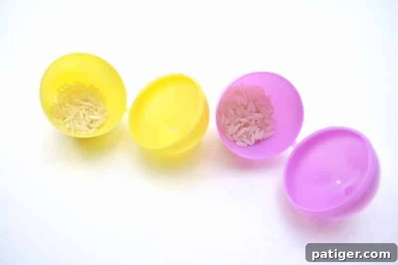 A child filling a plastic Easter egg with dried beans, preparing to make an Easter egg maraca.