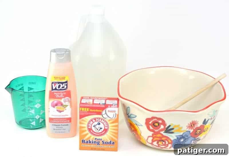 All the ingredients for homemade fabric softener laid out: a bottle of hair conditioner, a bag of baking soda, a bottle of distilled white vinegar, and a measuring cup with hot water.