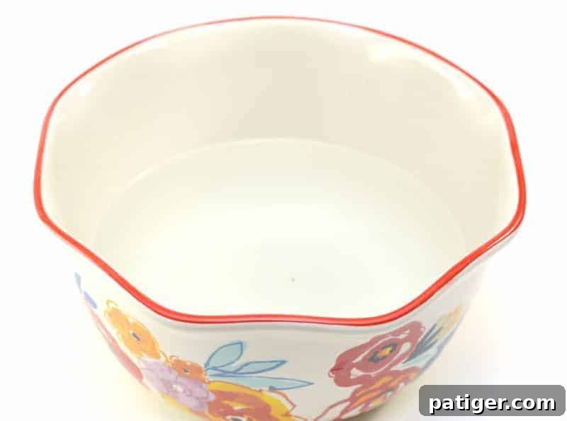 A large mixing bowl filled with hot water, ready for the next ingredient in the DIY fabric softener recipe.