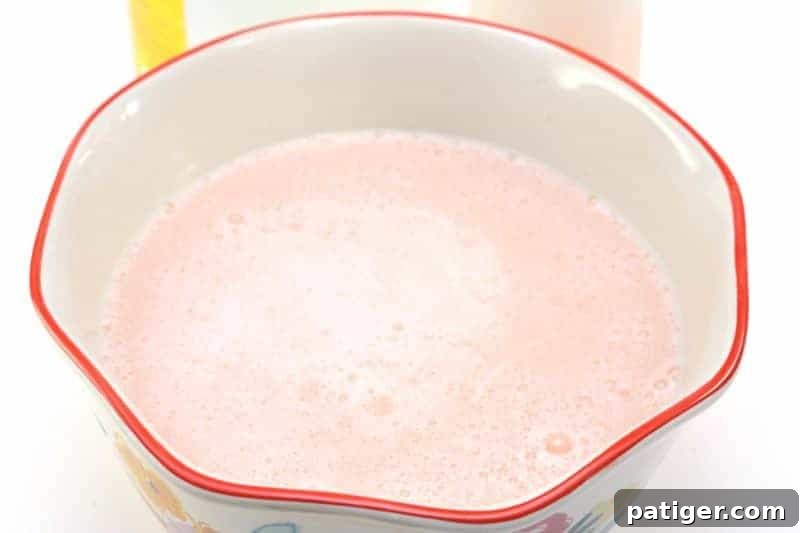 The finished DIY fabric softener resting in a large bowl, allowing the bubbles to dissipate before transferring to storage.