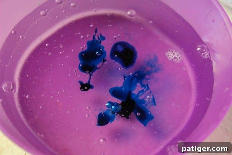 Adding blue soap colorant to the glue and water mixture to achieve an ocean hue.