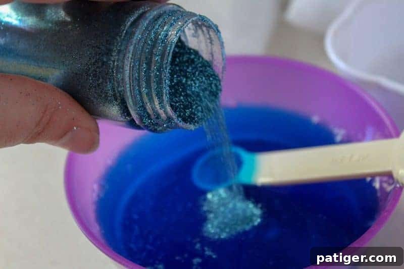 Incorporating blue extra fine glitter into the liquid slime mixture for a sparkling ocean effect.