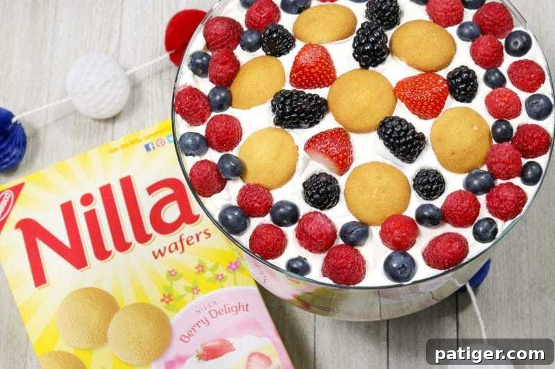 Stars and Stripes Berry Trifle 3 Close-up of a layered Patriotic Berry Trifle featuring Nilla Wafers, vanilla pudding, and fresh berries.
